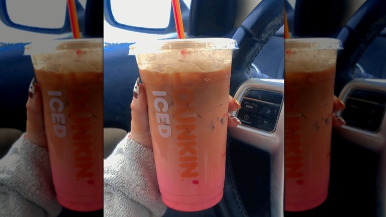 Hand holding Pink Velvet Macchiato in car
