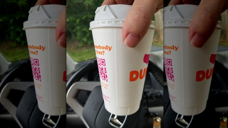 Hand holding Vanilla Chai Latte cup in car