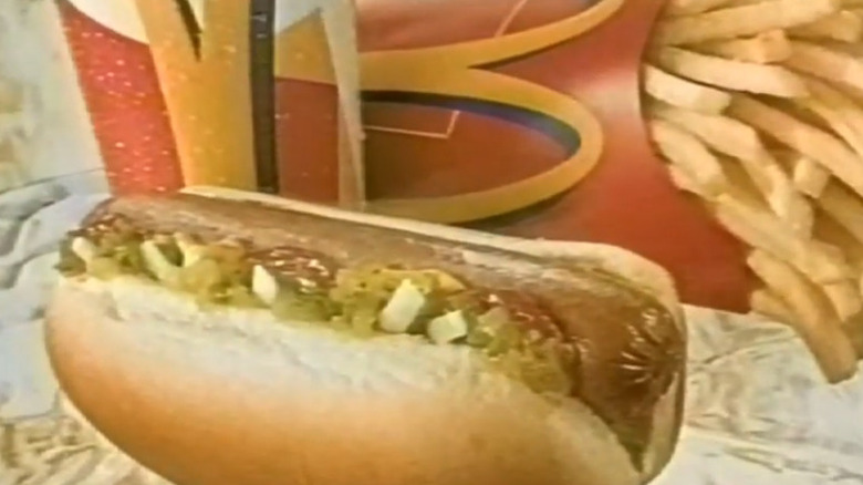 Screenshot from TV commercial for McDonald's short-lived McHotDog, in front of fries and drink.