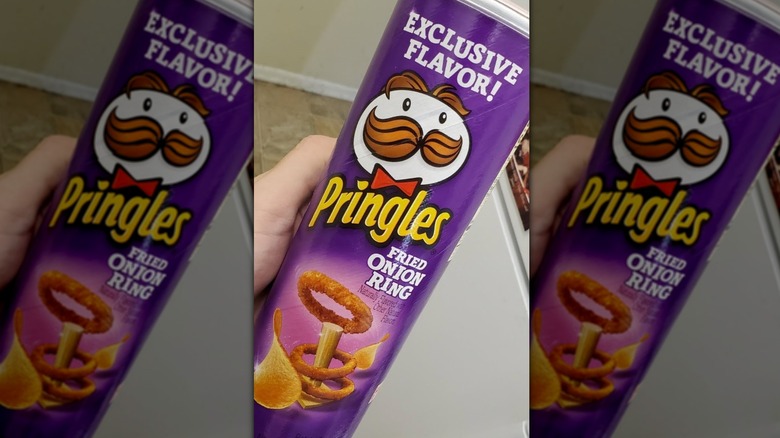 Fried Onion Ring Pringles can held sideways, fridge in the background