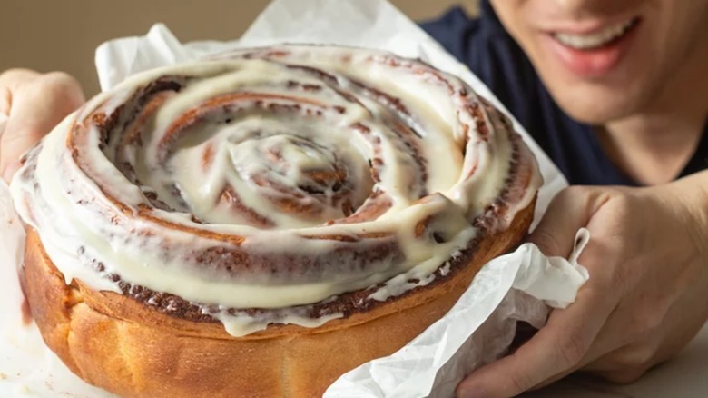 Man holding giant cinnamon roll