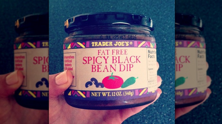 Hand holding jar of Fat-Free Spicy Black Bean Dip
