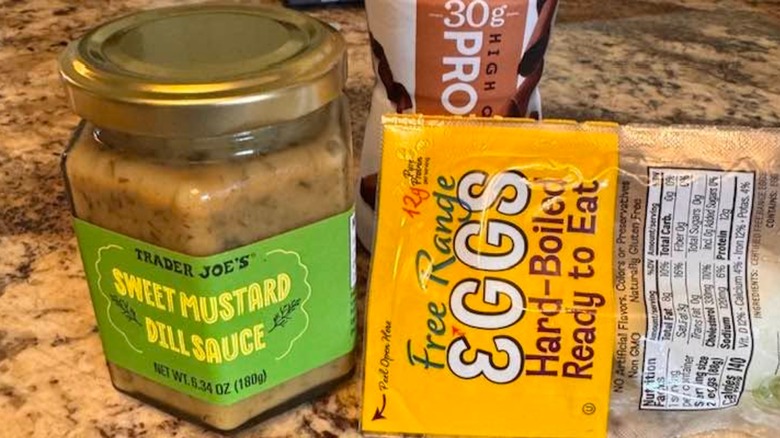 Trader Joe's Sweet Mustard Dill Sauce on countertop next to package of boiled eggs
