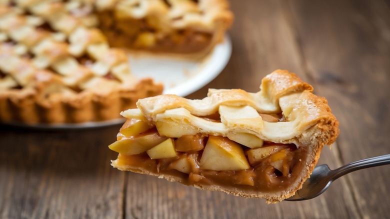 A slice of apple pie being served