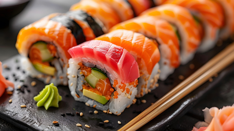Two sliced sushi rolls on a platter