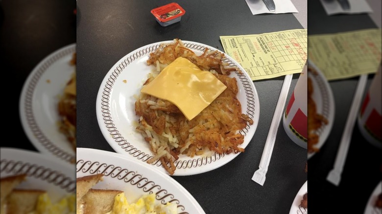 Covered hash browns on white plate at Waffle House
