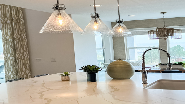 Three glass pendants hanging in the kitchen