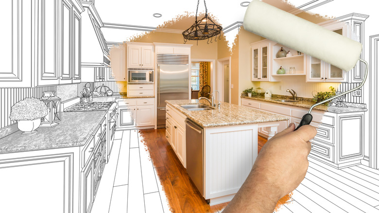 Man holding painting roller to reveal freshly remodelled kitchen underneath pencil-drawn plans