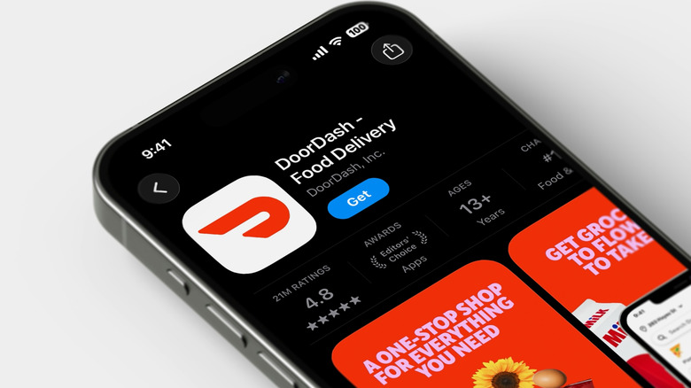 DoorDash app on black phone with white background