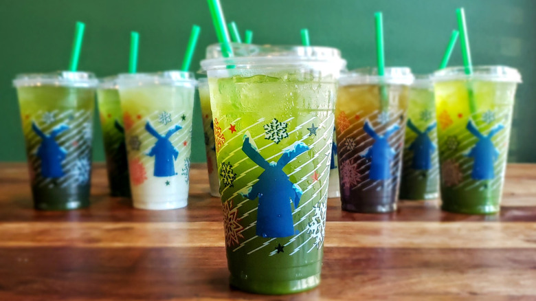 Passion fruit matcha lemonade from Dutch Bros on wooden table.