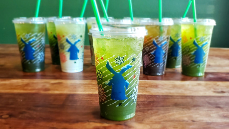 Watermelon matcha lemonade from Dutch Bros on wooden table.