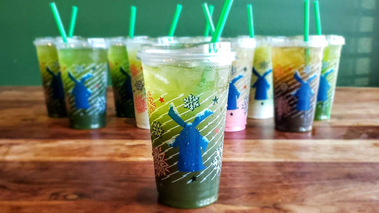 Peach matcha lemonade from Dutch Bros on wooden table.