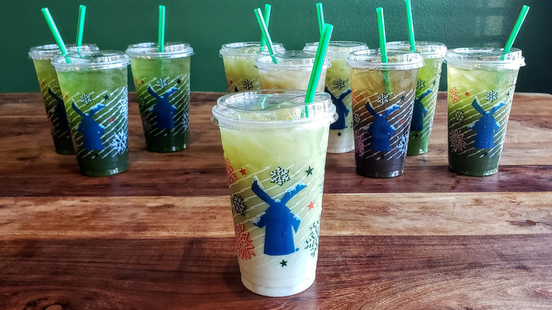 Vanilla matcha latte from Dutch Bros on wooden table.