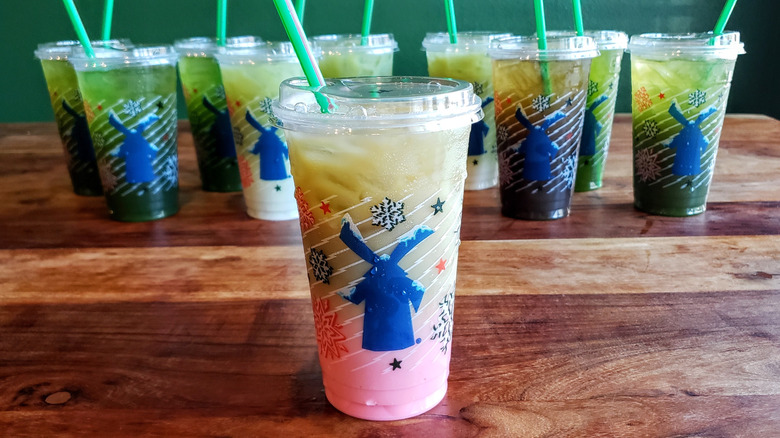 Raspberry matcha latte from Dutch Bros on wooden table.