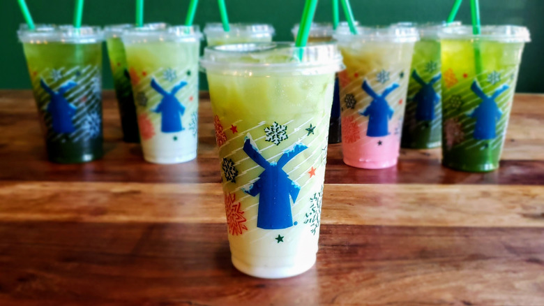 White chocolate matcha latte from Dutch Bros on wooden table.