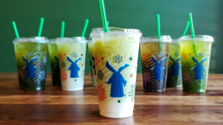 Lavender matcha latte from Dutch Bros on wooden table.