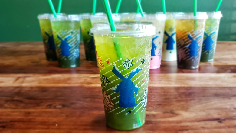 Watermelon matcha lemonade from Dutch Bros on wooden table.