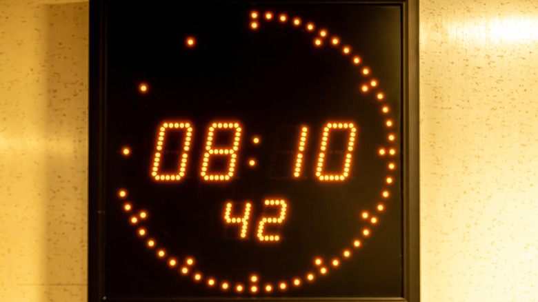 Illuminated digital clock placed on a wall