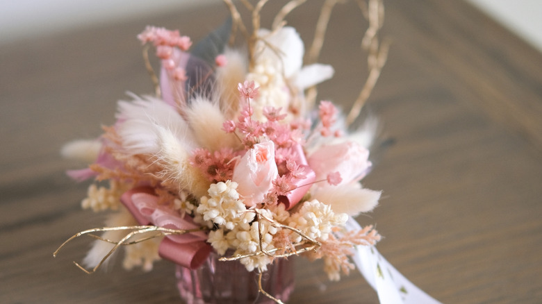 Elegant dried flower arrangement in glass vase