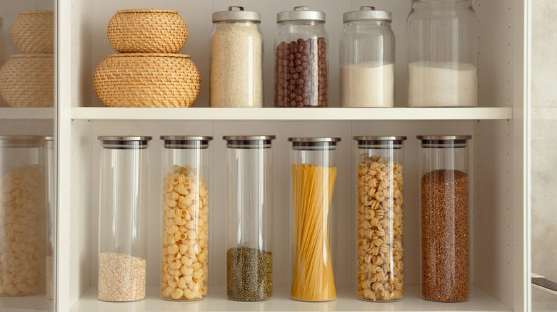 Uniform kitchen containers placed on kitchen shelves