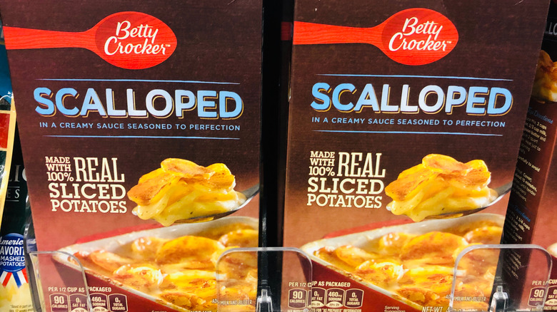 Two boxes of Betty Crocker scalloped potatoes on grocery store shelf