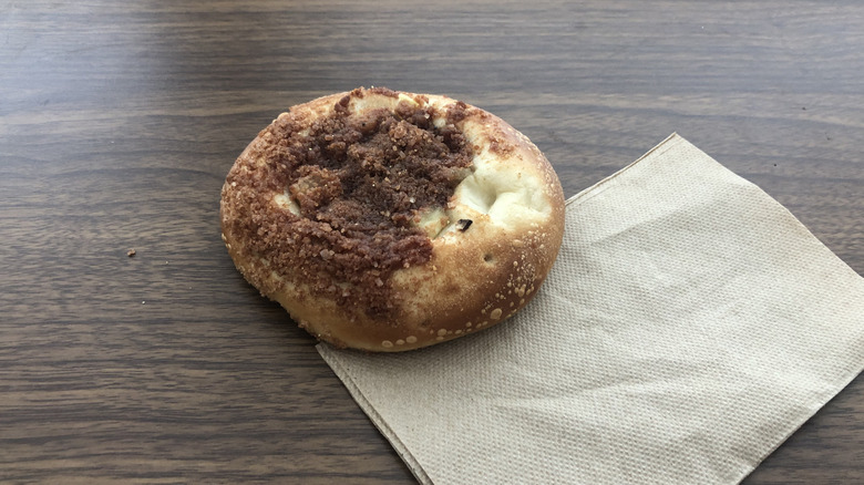 Einstein Bros apple cinnamon bagel on a napkin.