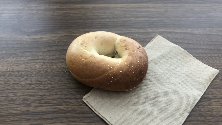 Einstein Bros plain bagel on a napkin.