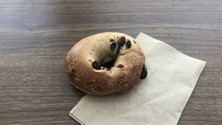 Einstein Bros cinnamon raisin bagel on a napkin.