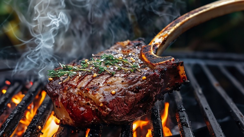 Steak being grilled on a charcoal grill