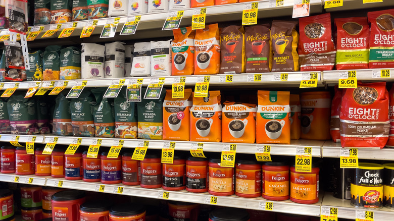Folgers and Dunkin coffee for sale on shelves at grocery store