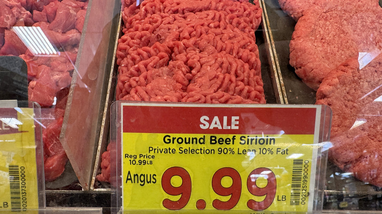 Ground beef sirloin with sale sign in butcher department