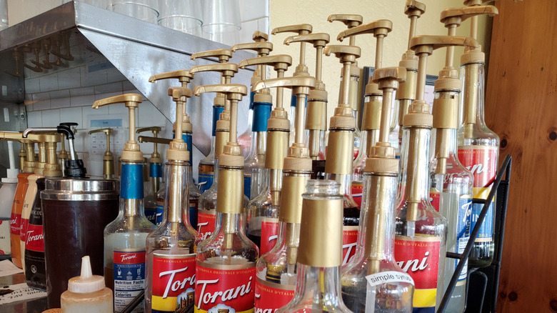 display of multiple coffee syrup bottles