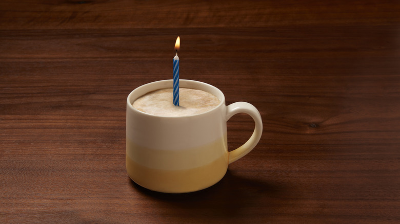 coffee in mug with a birthday candle inside