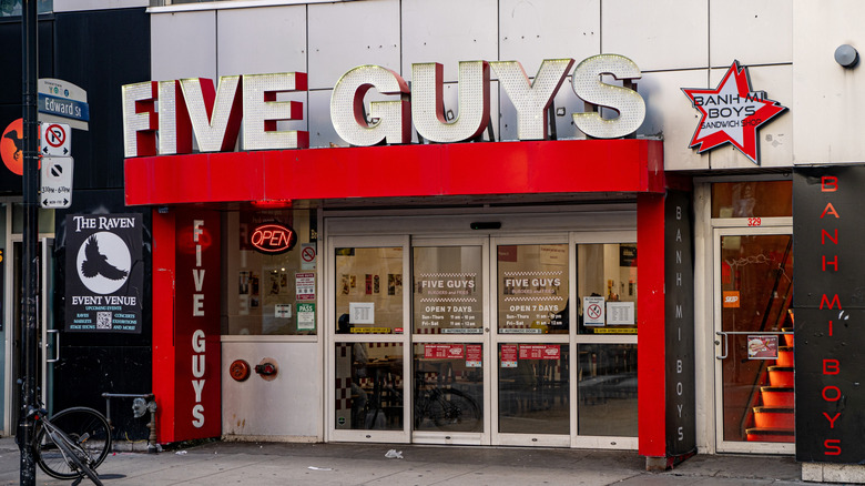 Five Guys restaurant with logo sign on the street in Downtown Toronto.
