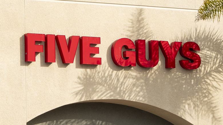 close up of the Five Guys sign on the wall outside a restaurant