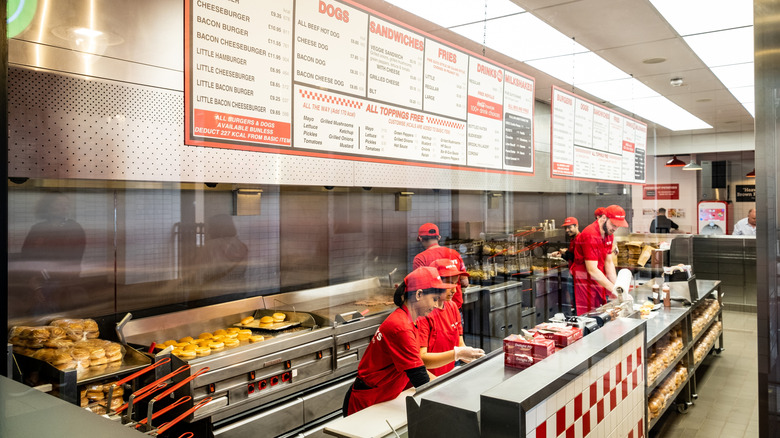 Interior of a Five Guys burger chain restaurant with workers at the counter