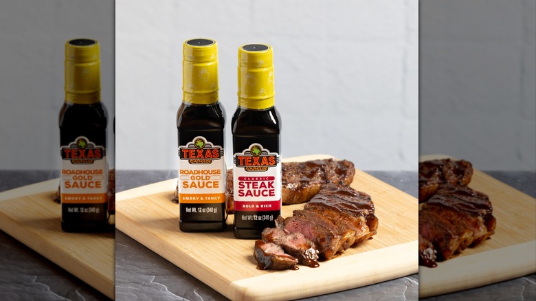 Texas Roadhouse steak and steak sauces on wooden cutting board