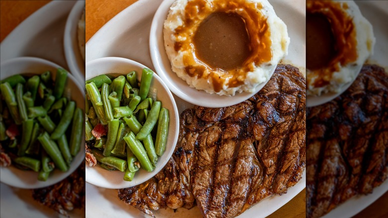 Texas Roadhouse steak, mashed potatoes, and green beans on white plate
