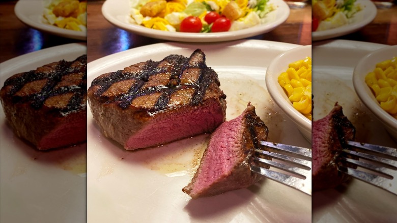 Texas Roadhouse steak cut in half on white plate