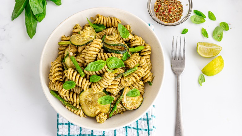 Rotini tossed in pesto, topped with zucchini and asparagus