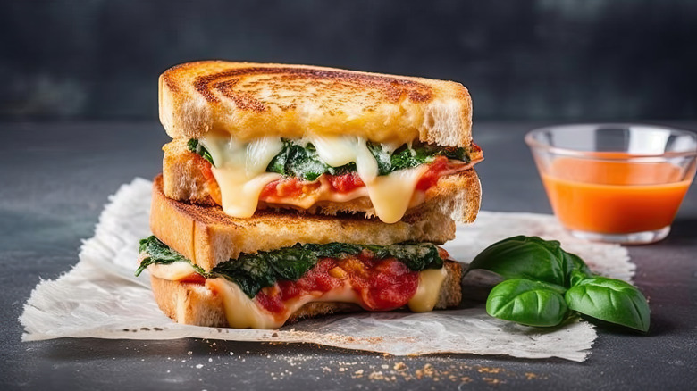Grilled cheese sandwich filled with cheese and tomato