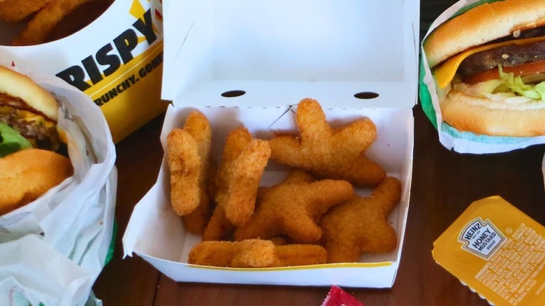 Carl's Jr. fried chicken stars in open container.
