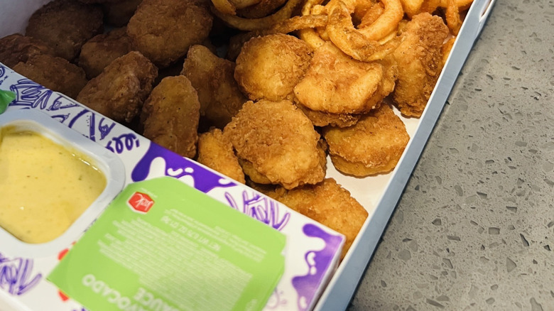 Jack in the Box munchie box with close up of chicken nuggets.