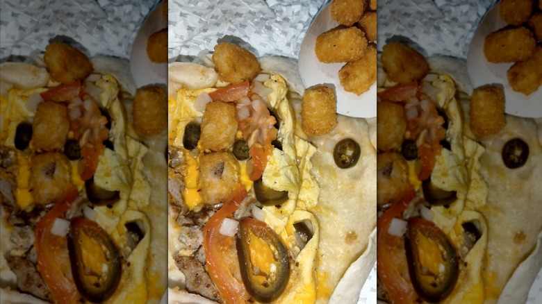 Sonic breakfast burrito and tots on paper wrapper