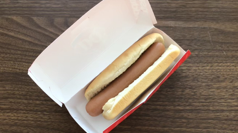 Dairy Queen plain hot dog in paper box on wooden table