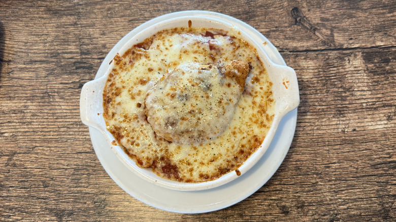 Fazoli's chicken parmesan inside a round white dish on wood
