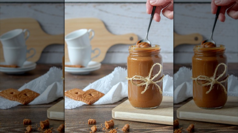 Person stirring jar of cookie butter