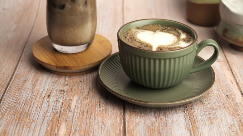 Hojicha hot and iced lattes on wood backdrop