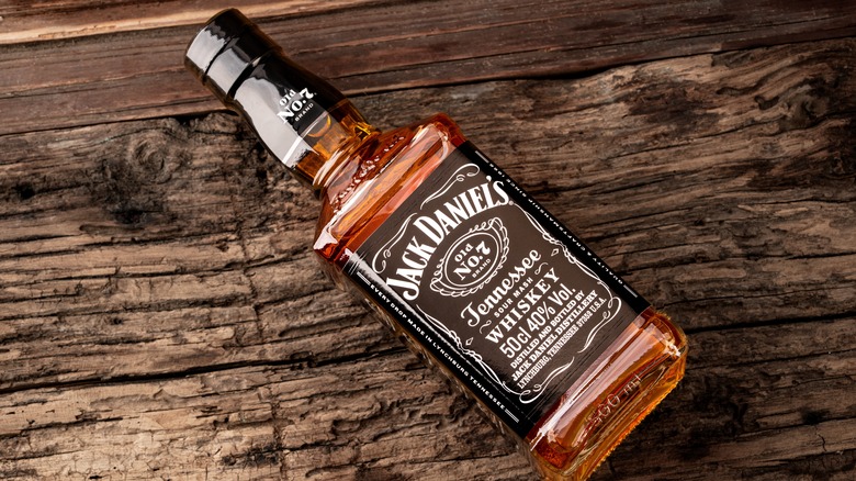 Bottle of Jack Daniels on wooden background