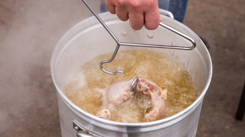 Deep-frying turkey in large metal container
